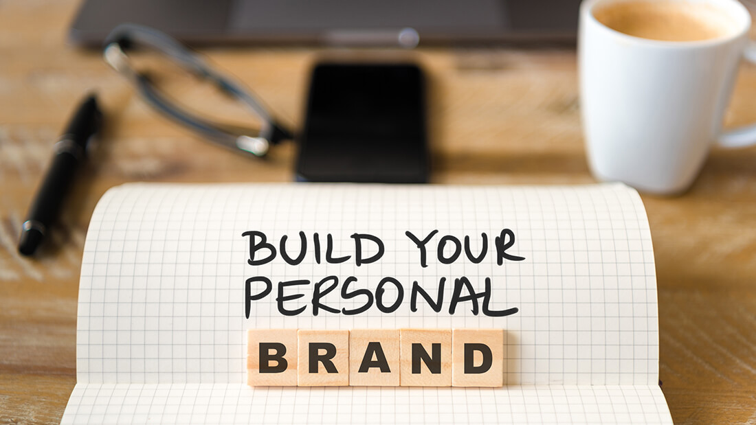 A wooden block that says build your personal brand.