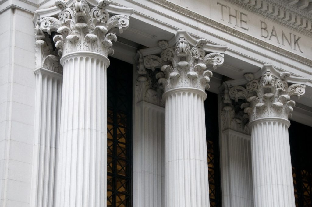 A close up of four pillars on the side of a building