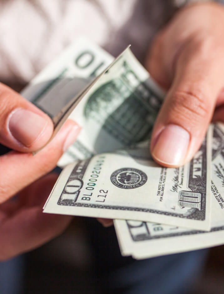 A person holding money in their hands