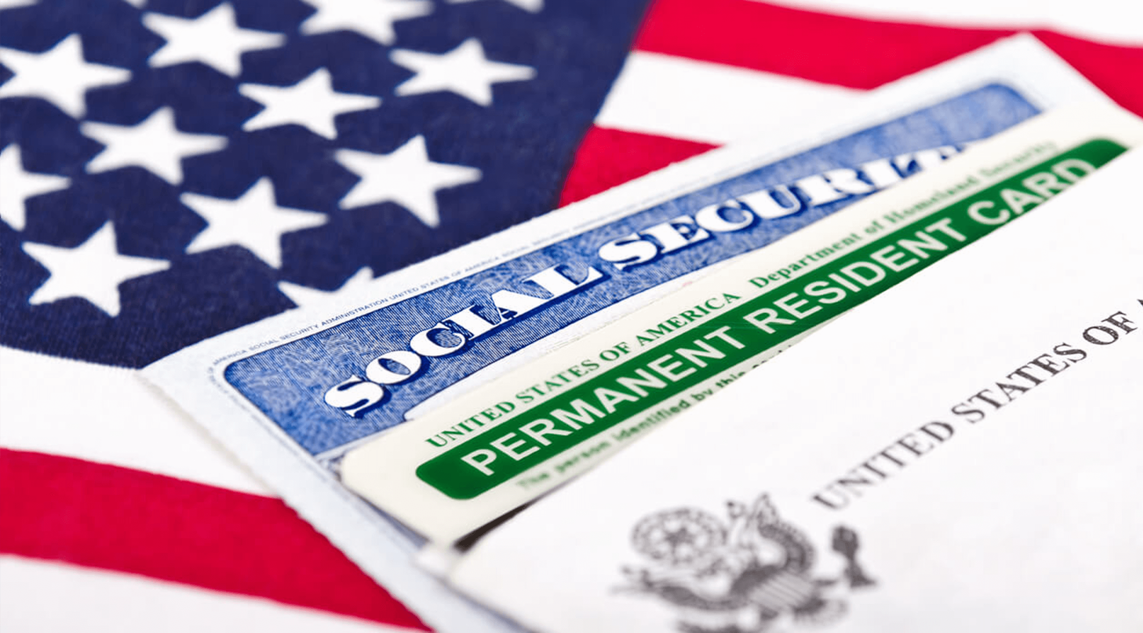 A social security card sitting on top of an american flag.