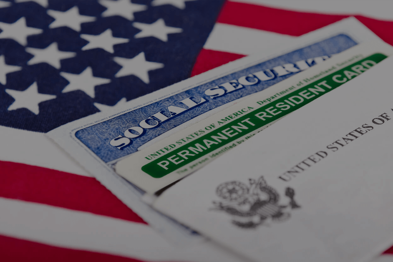 A social security card sitting on top of an american flag.