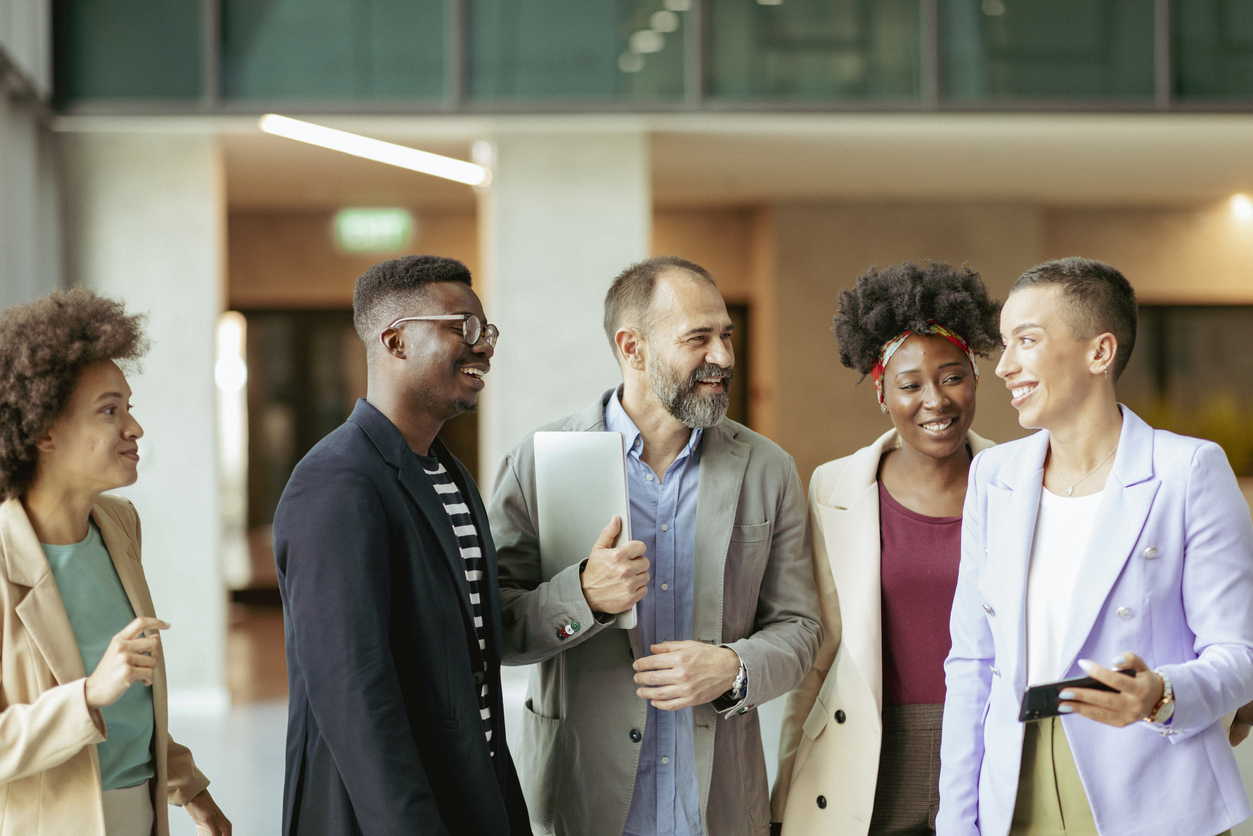 A group of people standing around each other.